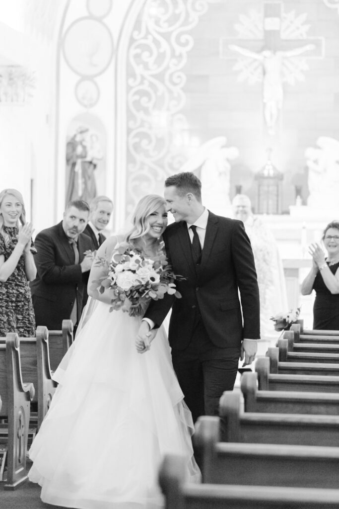 wedding couple walking down the aisle as newlyweds